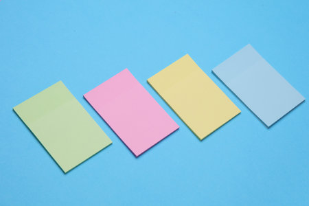 Set of colored memo stickers on blue backgroundの写真素材