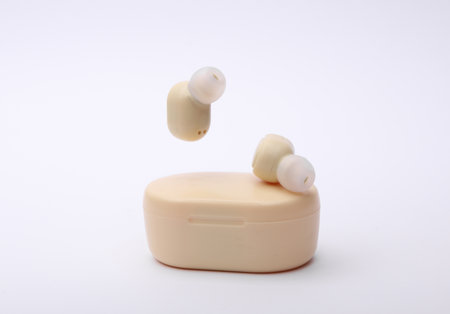 Wireless headphones with charging case on white backgroundの写真素材