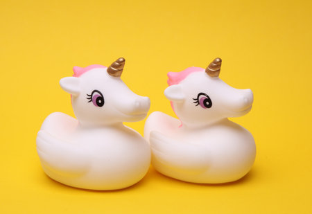 Rubber bath unicorns on a yellow background.の写真素材