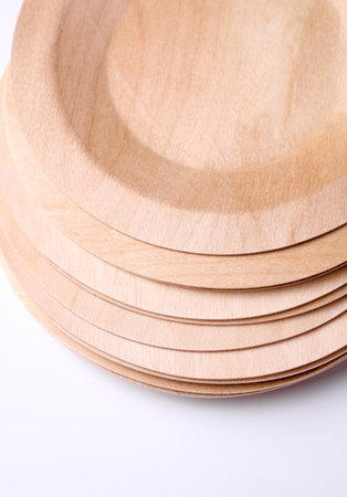 Stack of eco wooden plates on white backgroundの写真素材