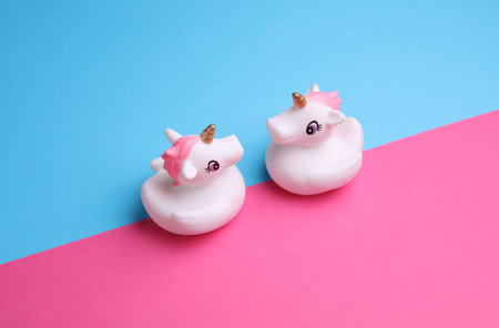 Rubber bath unicorns on a blue and pink background. Creative layoutの写真素材