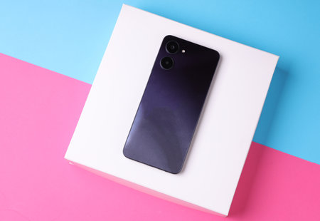 Modern smartphone with dual camera on white standの写真素材