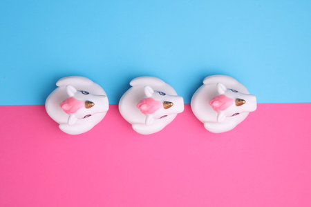 Rubber bath unicorns on a pink blue background. Top view. Creative layoutの写真素材