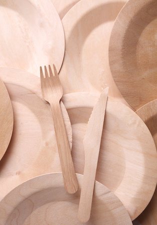 Set of wooden eco dishes on a white background. Plates, fork and knifeの写真素材