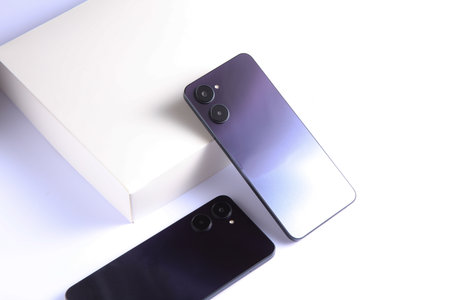 Two modern smartphones with dual camera, view from the back cover. White backgroundの写真素材