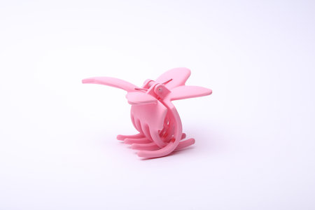 Pink plastic hair clip on white backgroundの写真素材