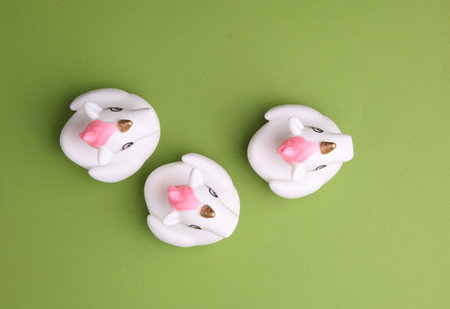 Rubber bath unicorns on a green background. Top view. Creative layout