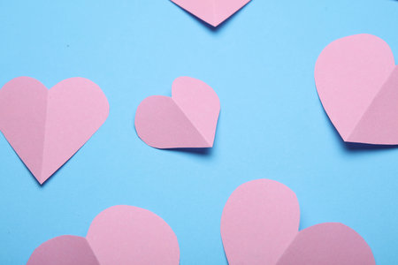 Pink Paper hearts on blue pink background. Love conceptの写真素材