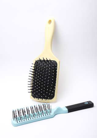 Two Hair brushes, plastic combs on white backgroundの写真素材