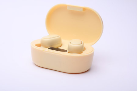 Wireless headphones with charging case on white background
