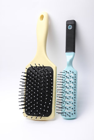 Two Hair brushes, plastic combs on white backgroundの写真素材