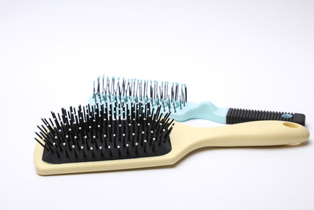 Two Hair brushes, plastic combs on white backgroundの写真素材