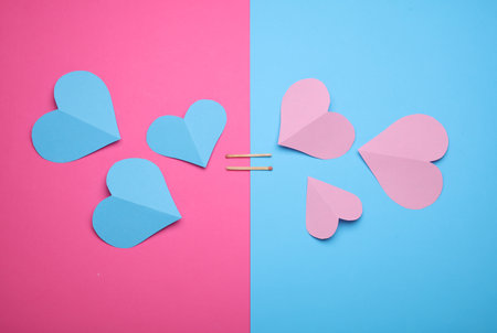 Paper hearts on a blue and pink background. Love conceptの写真素材