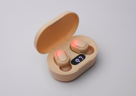 Wireless headphones with charging case on white backgroundの写真素材