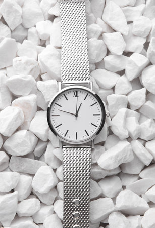 Women's Silver Wristwatch on White Pebblesの写真素材