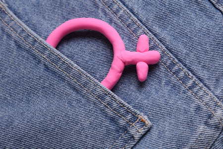 Female pink gender symbol in jeans pocketの写真素材