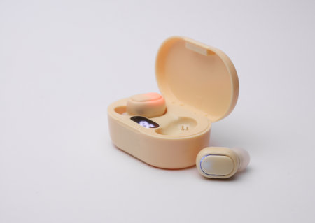 Wireless headphones with charging case on white backgroundの写真素材