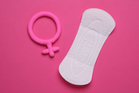 Pad with female gender symbol on pink background. Menstruation, critical days, female menstrual cycleの写真素材