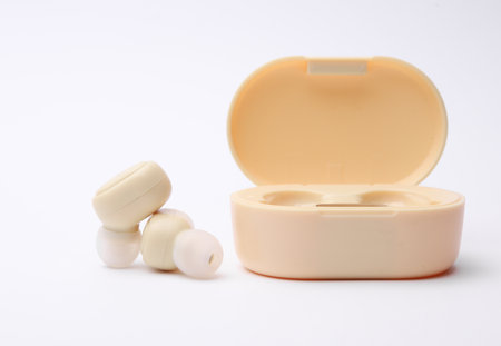 Wireless headphones with charging case on white backgroundの写真素材