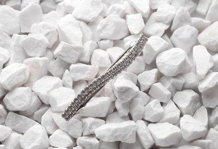 Jewelry pin on white pebbles close upの写真素材