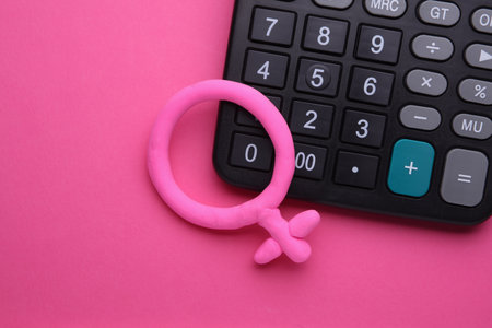 Calculator with female gender symbol on pink backgroundの写真素材