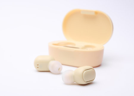 Wireless headphones with charging case on white backgroundの写真素材