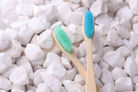 Eco bamboo toothbrushes on white pebblesの写真素材