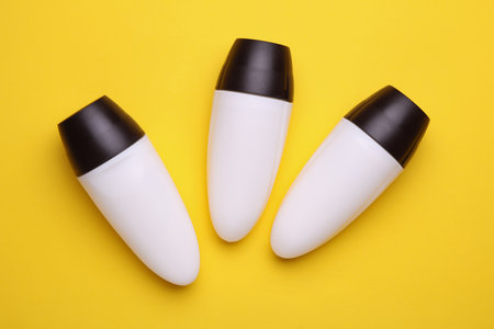 White antiperspirant tube sticks on yellow backgroundの写真素材