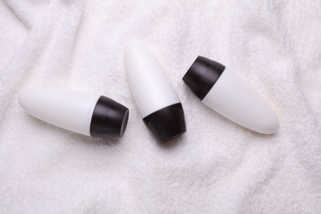 White antiperspirant tube sticks on towel background. Top viewの写真素材