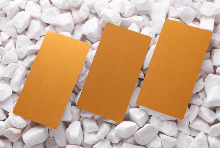 Golden business cards on white pebblesの写真素材