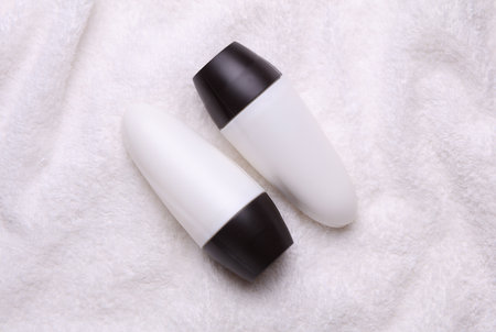 White antiperspirant tube sticks on towel background. Top viewの写真素材
