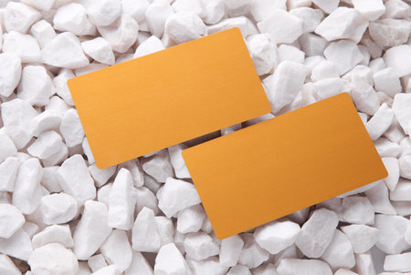 Golden business cards on white pebblesの写真素材