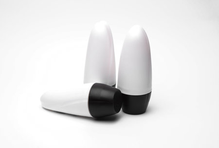 White antiperspirant tube sticks on white background