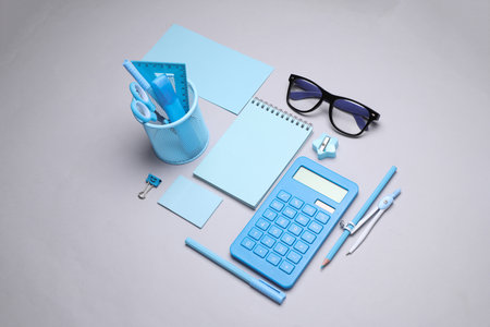 Blue Stationery set on gray background. Back to school, education, office supplies. Flat lay. Top view. Creative layoutの写真素材