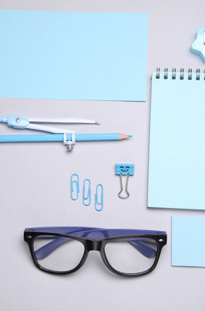 Blue Stationery set on gray background. Back to school, education, office supplies. Flat lay. Top view. Creative layoutの写真素材
