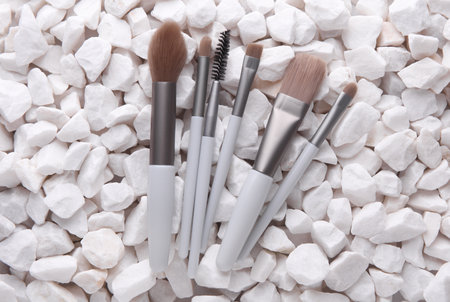 Set of makeup brushes on white pebblesの写真素材