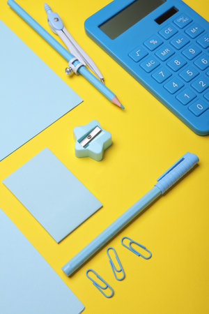 Blue Stationery set on yellow background. Back to school, education, office supplies. Flat lay. Top view. Creative layoutの写真素材