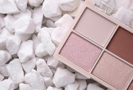 Makeup eyeshadow palette on white pebblesの写真素材