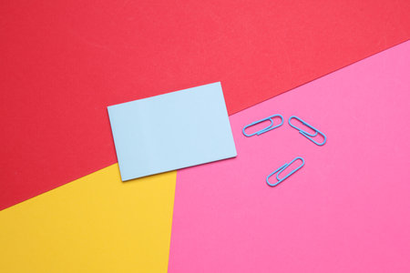 Memo stickers with paper clips on a colored backgroundの写真素材