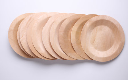 Stack of eco wooden plates isolated on whiteの写真素材