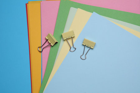 Binder clips and Set of Colored Paper Sheetsの写真素材