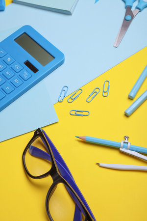 Blue Stationery set on yellow background. Back to school, education, office supplies. Flat lay. Top view. Creative layoutの写真素材