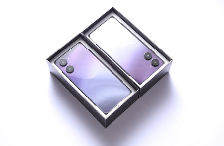Two new modern smartphones in boxes on white backgroundの写真素材