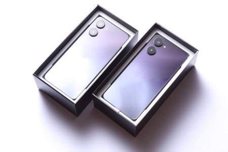 Two new modern smartphones in boxes on white backgroundの写真素材