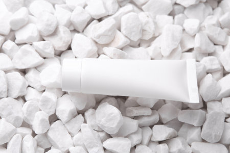 White cream tube on pebbles close upの写真素材