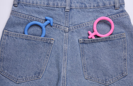 Female and male gender symbols in jeans pocketの写真素材