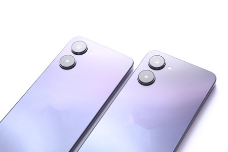 Two modern smartphones with dual camera, view from the back cover. White backgroundの写真素材