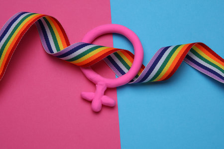 Female gender symbol with lgbt rainbow ribbonの写真素材
