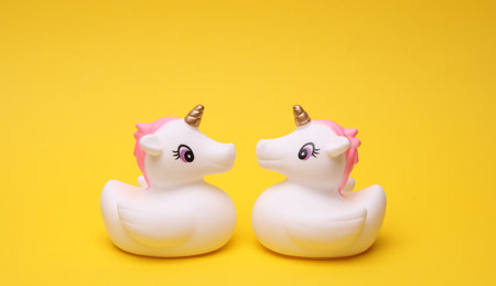 Rubber bath unicorns on a yellow background.の写真素材
