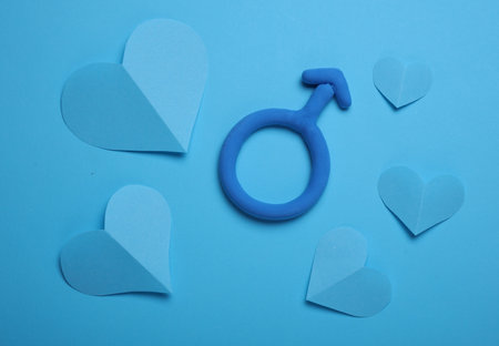 Male gender symbol made of plasticine and hearts on blue background. Love conceptの写真素材